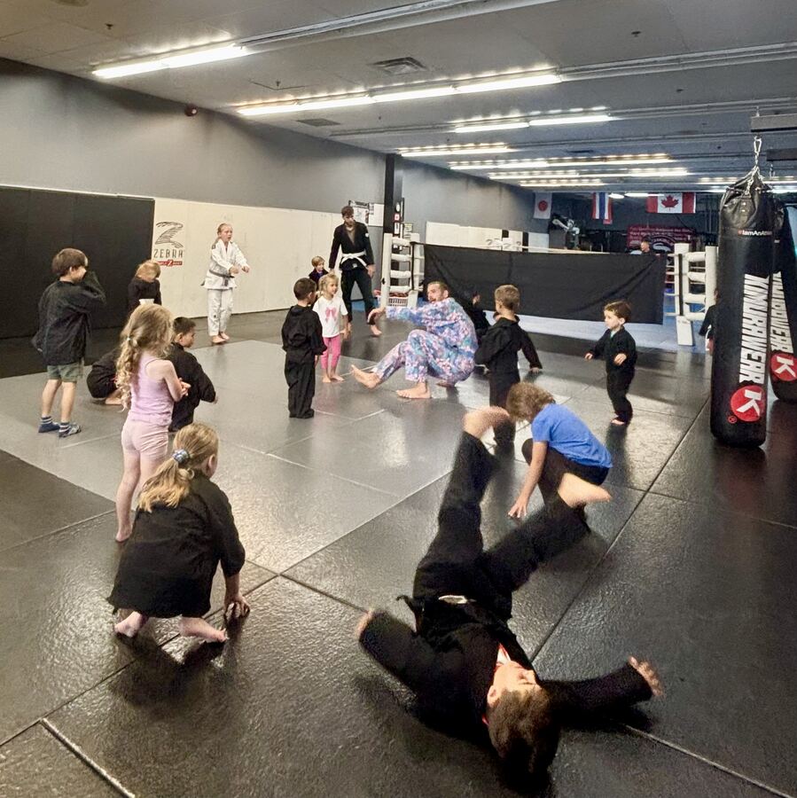 Kids training on the mats at Rumble Martial Arts during the after-school program.