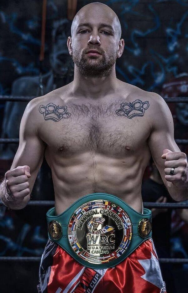 A Rumble fighter Kru Jones trained from scratch, wearing his WBC Muay Thai professional championship belt.