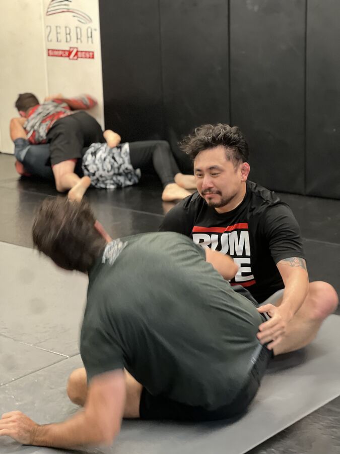 Adults drilling No-Gi Brazilian Jiu-Jitsu on the mats at Rumble Martial Arts in Keswick