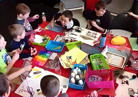 After-school kids doing arts and crafts at the table.