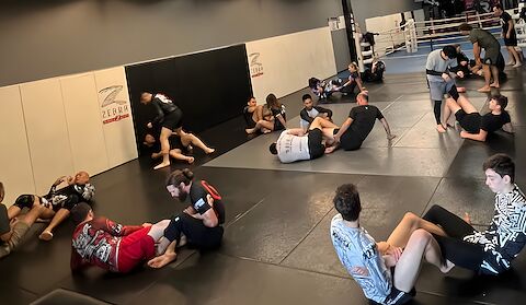 Students rolling and working leg locks during a seminar at Rumble Martial Arts.
