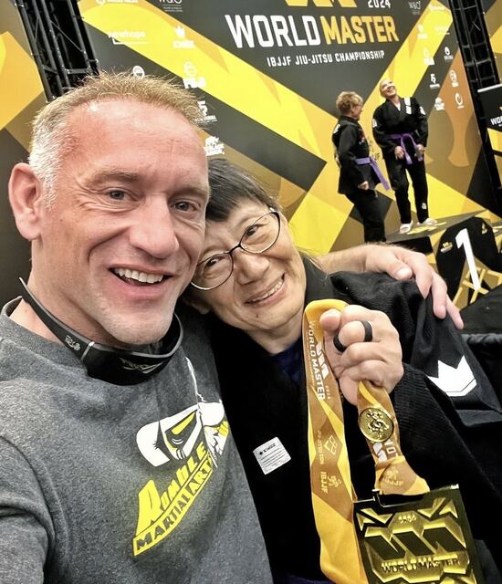 Coach Gladys and Professor Jones celebrating her World Master gold medal.